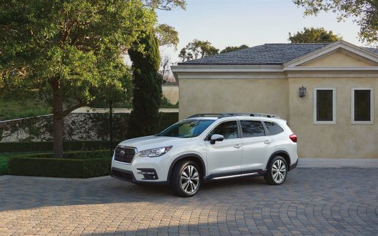 Image of a white 2019 Subaru Ascent parked in front of a house.