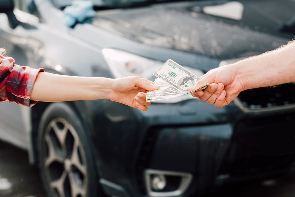 Handing Over Cash for Car Payment