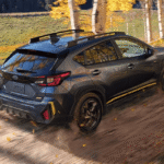 2027 Subaru Crosstrek driving down a gravel road